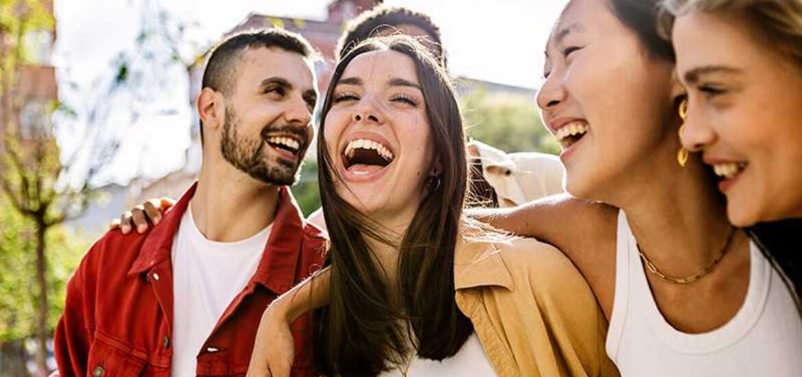 A group of college students laugh together.