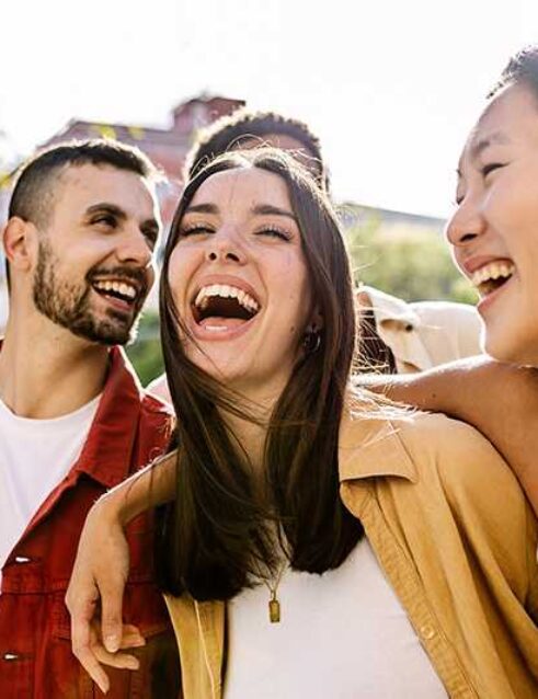 A group of college students laugh together.