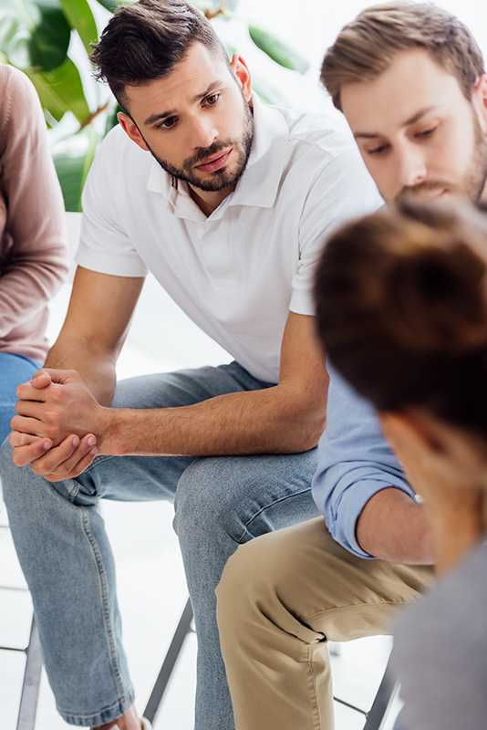 People participate in group therapy at a bipolar disorder treatment center.