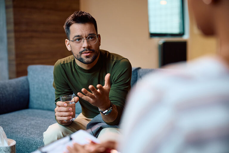 A man speaks to his therapist at a fentanyl addiction treatment center.