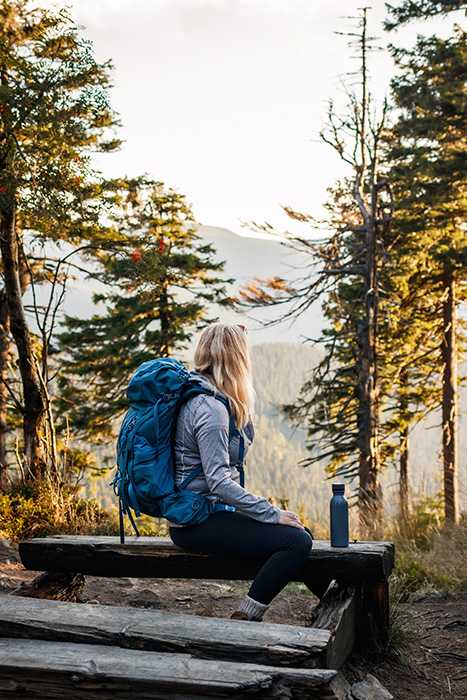 A woman looks at the view while hiking.