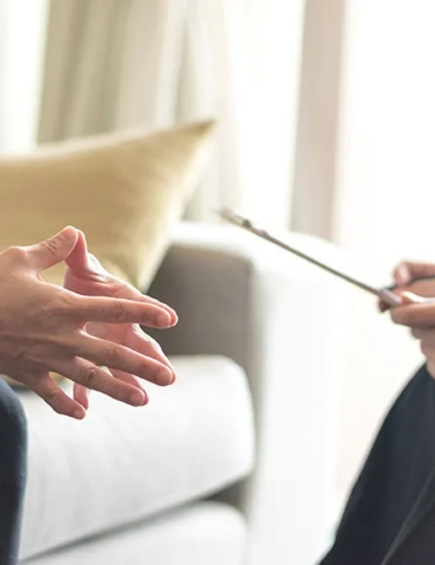 A client discusses transcranial magnetic stimulation with a provider.