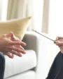 A client discusses transcranial magnetic stimulation with a provider.