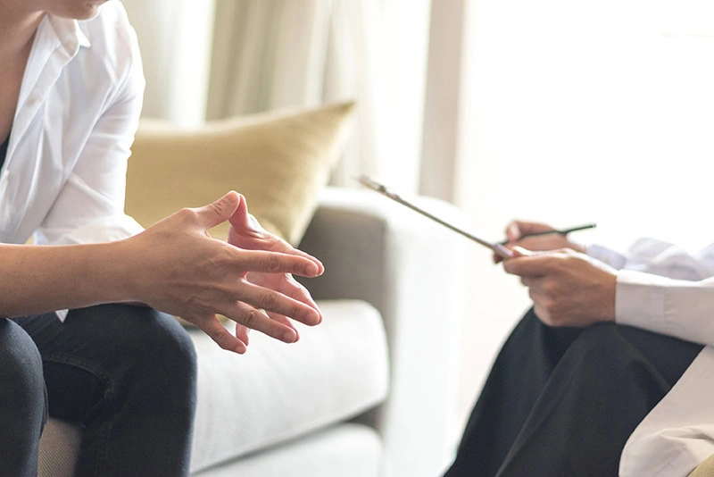 A client discusses transcranial magnetic stimulation with a provider.