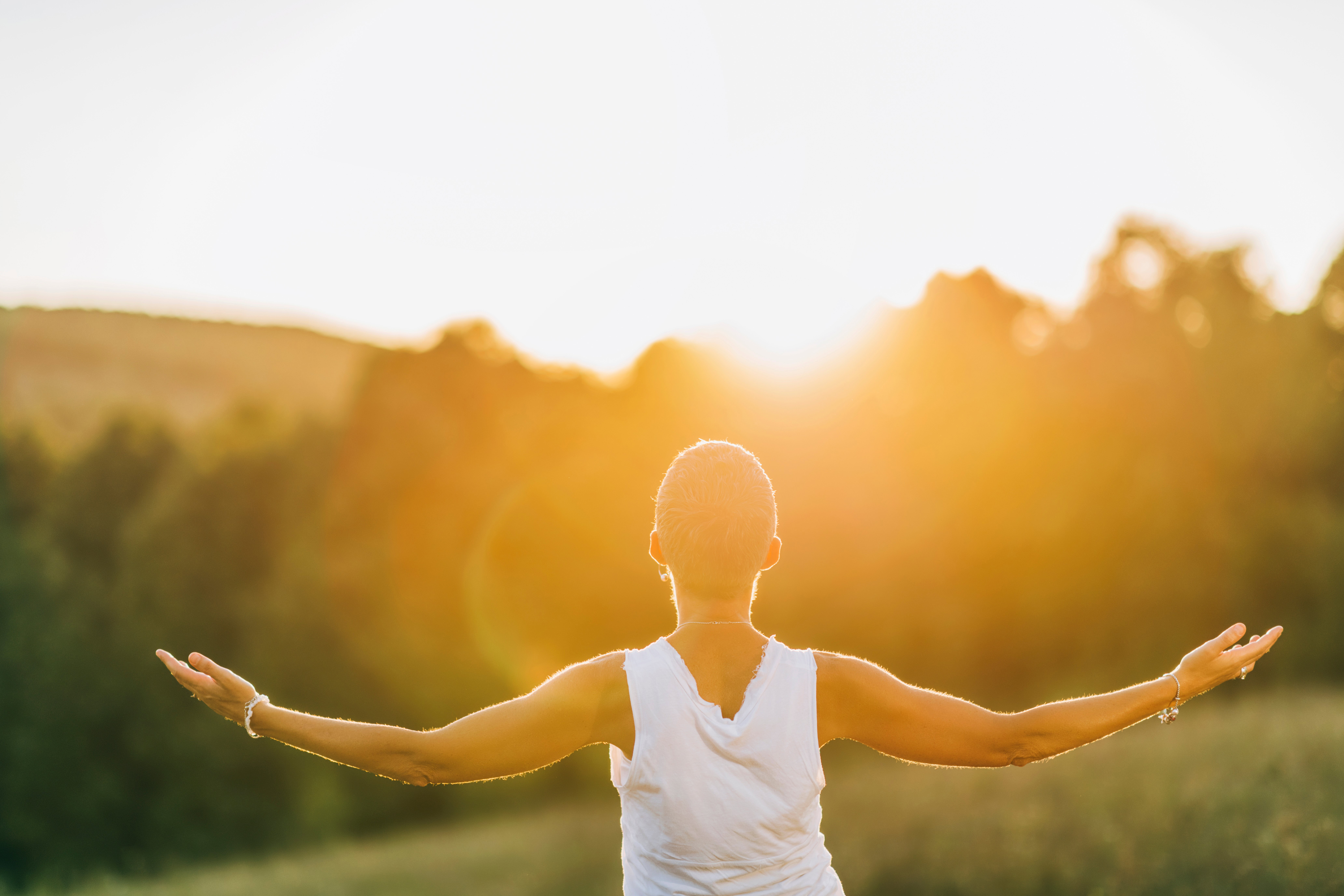 A woman with her arms spread for her acceptance in recovery.