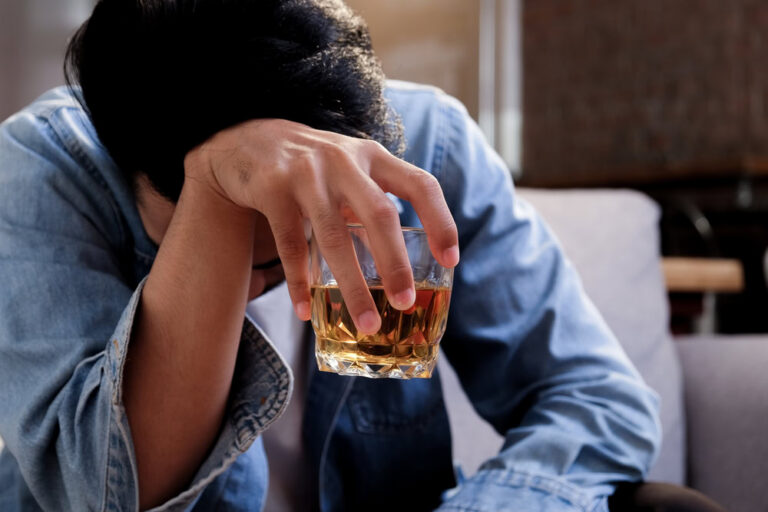 Man having a drink contemplating how long does it take to get addicted to alcohol​.